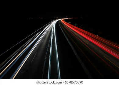 light trails on highway at night, long exposure photo - Shutterstock ID 1078575890