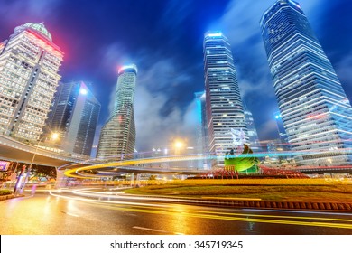 the light trails on the modern building background in shanghai china. - Shutterstock ID 345719345