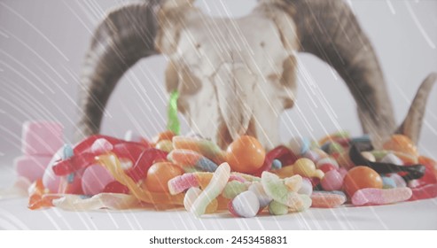 Light trails over halloween candies and goat horns and skull against white background. halloween celebration concept - Powered by Shutterstock