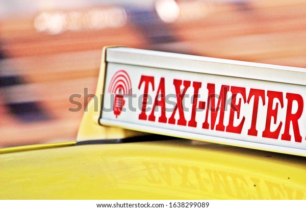 Light turned on on Taxi meter sign on car room for\
passenger or customer in