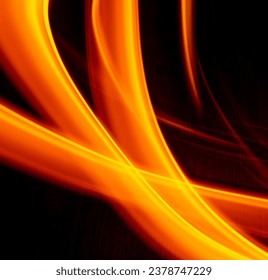 Light wave trail path, vibrant neon gold color in abstract swirls on a black background. Light painting