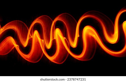 Light wave trail path, vibrant neon gold color in abstract swirls on a black background. Light painting - Powered by Shutterstock - Get 15% off with code: PIKWIZARD15