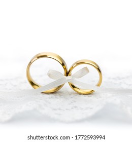 Light Wedding Celebration background - pair of wedding rings with bow