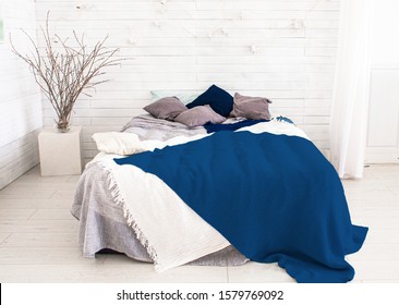 Light, White, Spacious Bedroom With A Large Bed, In The Scandinavian Style. Mockup And Free Space For Text And Pictures. Color Of The Year Pantone Classic Blue 2020