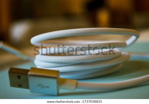 Сlose-up of a light white usb\
cable