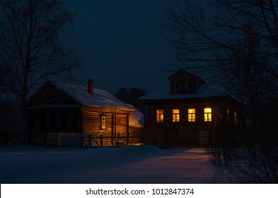 The Light In The Windows Of A Country House. Night, Winter, Village