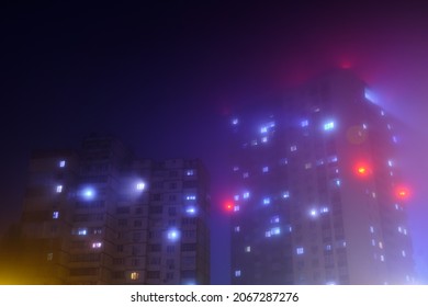 Light from windows in a residential building during foggy night.