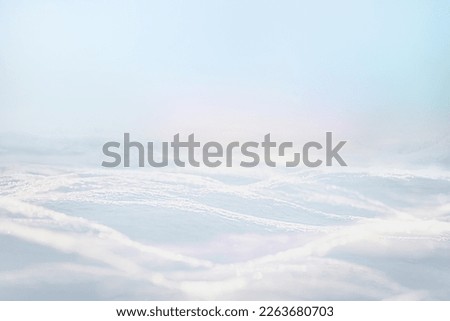 LIGHT WINTER BACKGROUND WITH SUN LIGHT FROM THE CLEAR BLUE SKY, WHITE SNOW BACKDROP FOR WINTER OR CHRISTMAS MONTAGE