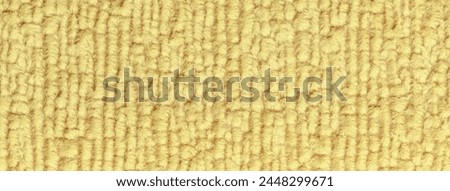 Light yellow fluffy background of soft, fleecy cloth. Texture of textile closeup