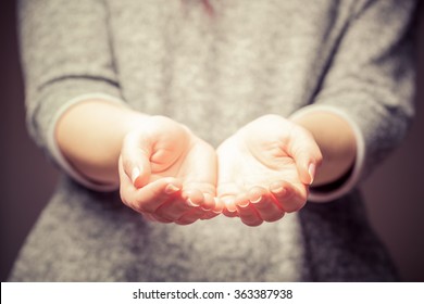 Light In Young Woman's Hands. Palms In Cupped Shape. Concepts Of Sharing, Giving, Offering, Taking Care, Protection. 