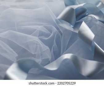 Light-blue Satin Ribbon On Pastel Blue Tulle Fabric 