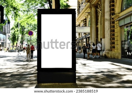 lightbox billboard on tourist walking street. blank white poster and ad space. digital outdoor display. base for mockup. empty display panel. glass design. soft streetscape. shopping street background