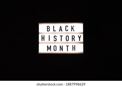 Lightbox with text BLACK HISTORY MONTH on dark black background. Message historical event. Light