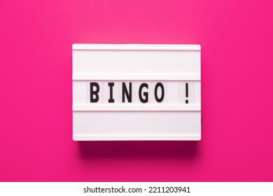 Lightbox with word bingo on pink background, top view. Bingo concept - lottery, casino, win game and jackpot - Shutterstock ID 2211203941