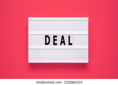 Lightbox with word deal on pink background. Business and Deal concept. Copy space. - Shutterstock ID 2232862319