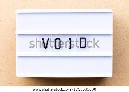 Lightbox with word void on wood background