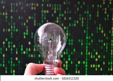Lightbulb in a hand with digital codes in the background