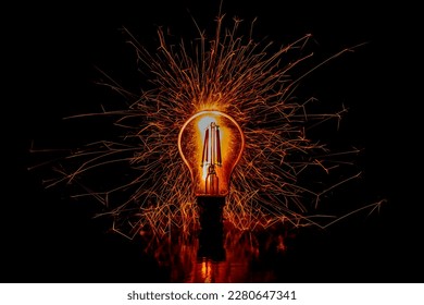 Lightbulb with sparks exploding around. Black background