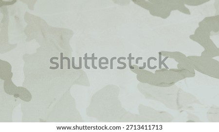 Light-colored camouflage patterned fabric surface.
