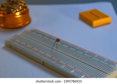 A light-controlled variable resistor called photoresistor or photocell is connected to a breadboard