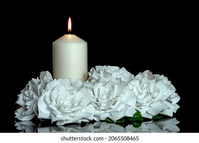 LIGHTED CANDLE AND ELEGANT WHITE ROSES ARRANGEMENT ON DARK BACKGROUND. ALL SOULS DAY, DEATH, DECEASE, PRAYER, MEMORIAL DAY, DUEL, MOURNING, GRAVE, CEMETERY, BURIAL, CONDOLENCE AND FUNERAL CONCEPT. - Shutterstock ID 2065508465