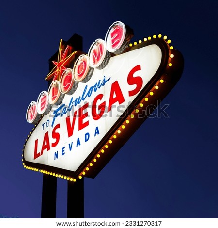 Lighted Las Vegas welcome sign with night sky.