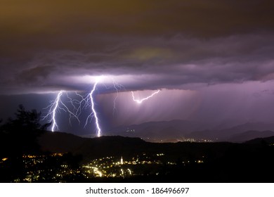 Lightening Bolts Behind A City