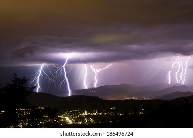 Lightening Bolts Behind A City