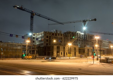 Lightening multi-storey buildings under construction and cranes at night. - Powered by Shutterstock