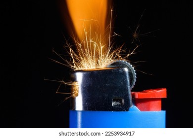 A lighter in close-up during the ignition with the sparks  - Shutterstock ID 2253934917