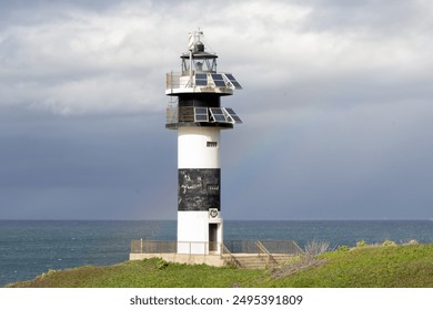 Lighthouse beacon on stormy coast, hope and guidance concept photo. Isla Pancha, Ribadeo, Spain - Powered by Shutterstock