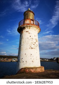 Lighthouse with blue sky and clouds