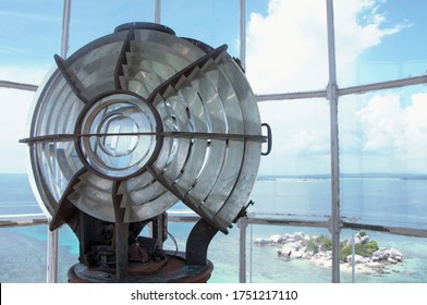 Lighthouse bulb glass room with turquoise ocean and pure white cloud in blue sky background  on selective focus