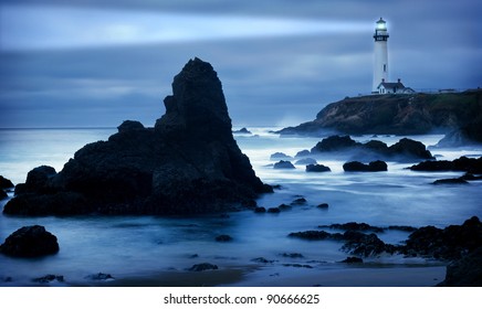 Lighthouse At The California Coast With Light Beam