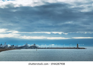 Lighthouse In Cannes, French Riviera. Blue Sky And Calm Water With The Beacon.