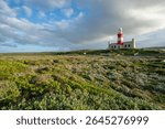 Lighthouse of Cape Agulhas, the geographic southern tip of Africa and the beginning of the traditional dividing line between the Atlantic and Indian Oceans