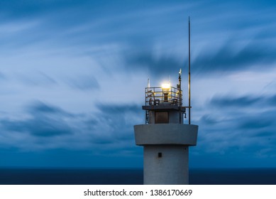 lighthouse with cloud as background at night
