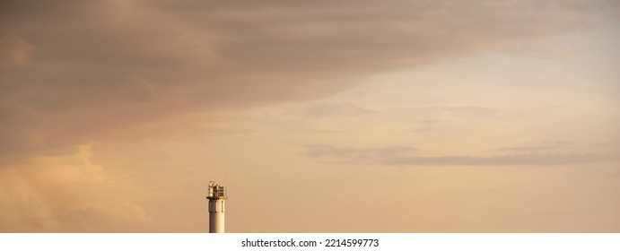 Lighthouse. Dramatic sunset sky. Glowing clouds, soft sunlight. Idyllic seascape. Nature, cruise, travel destinations. Symbol; of hope and peace