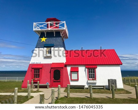 Lighthouse in Grande Anse in northern New Brunswick Canada in the colors of the Acadian Flag overlooking the Bay of Chaleur.