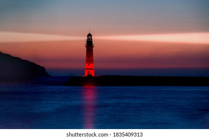 Lighthouse guiding ships at dusk - Shutterstock ID 1835409313