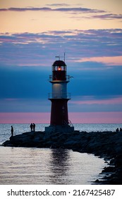 The lighthouse at the harbor entrance in Warnemuende in Germany in the evening light.