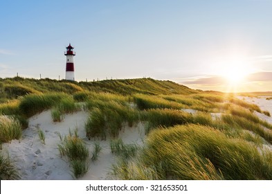 Lighthouse List East at sunset with sunstar, Ellenbogen, Sylt, Schleswig-Holstein, Germany
