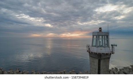 Lighthouse looking over the calm Black Sea on sunrise 