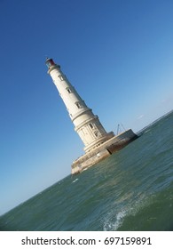 Lighthouse in the middle of the ocean.