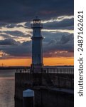 The Lighthouse in Newhaven Harbour in Edinburgh, Scotland, at sunset,  dramatic skies behind 