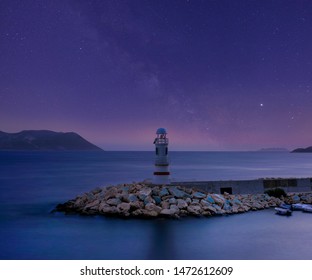 Lighthouse and night sky and Milky Way - Powered by Shutterstock