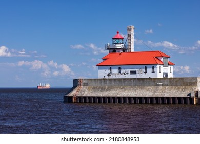 A Lighthouse On Lake Superior with A Ship - Shutterstock ID 2180848953