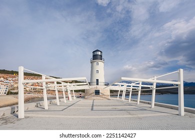 Lighthouse on the mall. broad walkway that ends with the beacon protecting the harbor. - Shutterstock ID 2251142427