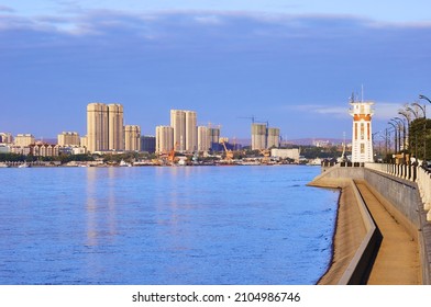 Lighthouse On The Pedestrian Promenade Of The City Of Blagoveshchensk, Russia. Summer Morning Over The Border River Amur After A Flood. View Of Heihe City, China. Flood Marks On The Embankment.