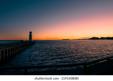 Lighthouse On A Peer At Sunset Over Water Beautiful Nature And Soft Colored Sky Landscape Photography Travel Concept In Montreal, Lachine, Quebec, Canada